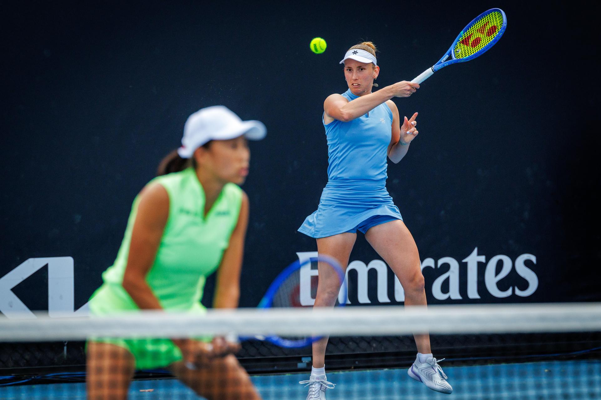 Belgian Elise Mertens (blue) and Chinese Zhang Shuai (green) pictured in action during a first round match of Belgium-China's Mertens-Shuai pair against Romania-Russia's pair Cirstea-Kalinskya in the women doubles at the Australian Open, Melbourne Park, Melbourne on Wednesday 21 January 2026. Mertens - Shuai won the game. BELGA PHOTO PATRICK HAMILTON --- BENELUX ONLY ---