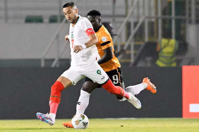 Morocco's midfielder #7 Hakim Ziyech (L) fights for the ball with with Zambia's forward #9 Lameck Banda during the Africa Cup of Nations (CAN) 2024 group F football match between Zambia and Morocco at the Stade Laurent Pokou in San Pedro on January 24, 2024. SIA KAMBOU / AFP