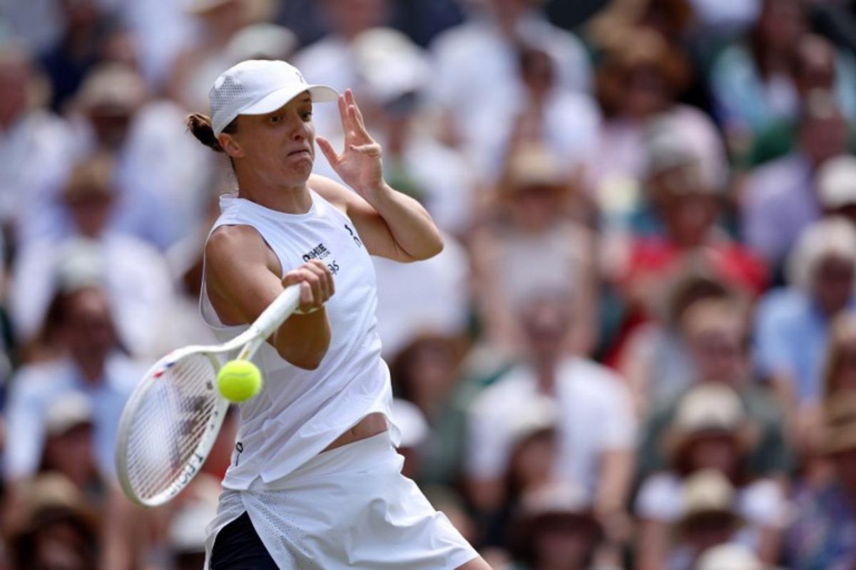Poland's Iga Swiatek returns to Philippines' Alexandra Eala during their women's singles third round tennis match on the sixth day of the 2026 Wimbledon Championships at The All England Lawn Tennis and Croquet Club in Wimbledon, southwest London, on July 4, 2026. Henry Nicholls / AFP
