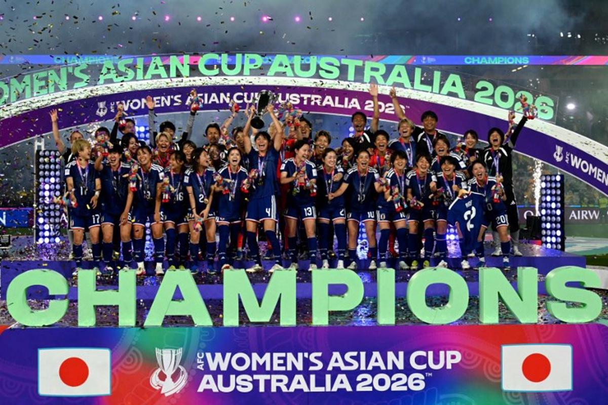 Japan's team celebrate with the trophy after winning the final of the AFC Women's Asian Cup Australia 2026 football tournament between Australia and Japan at Stadium Australia in Sydney on March 21, 2026. Saeed Khan / AFP