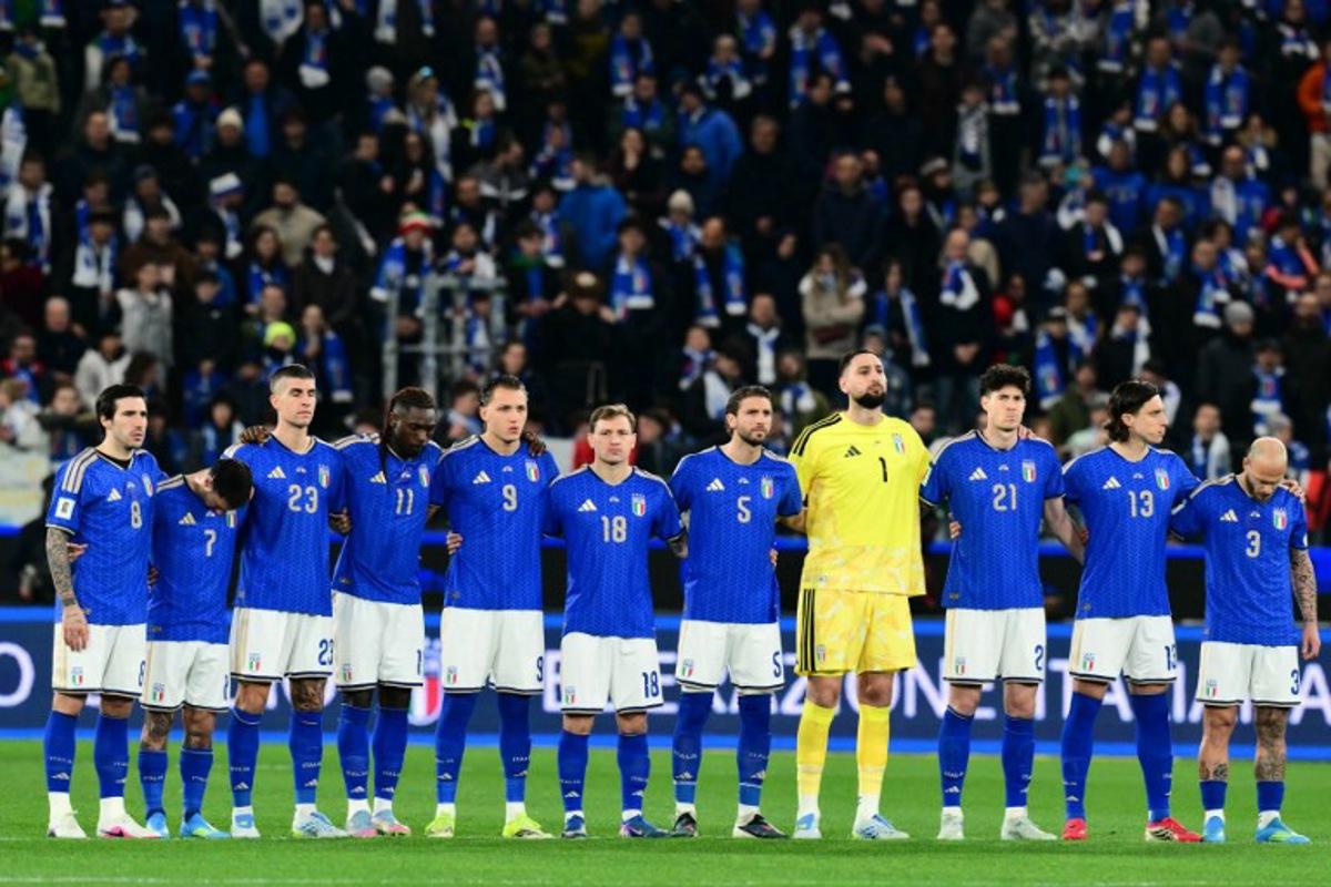 Italy's players stand on the pitch during the national anthems before the play-off FIFA World Cup 2026 European qualification semi-final football match between Italy and North Ireland at the Gewiss stadium in Bergamo, on March 26, 2026. Stefano RELLANDINI / AFP