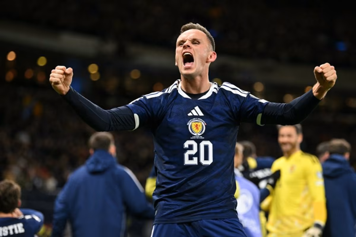 Scotland's striker #20 Lawrence Shankland celebrates on the pitch after the FIFA World Cup 2026 European qualification football match between Scotland and Denmark at Hampden Park in Glasgow on November 18, 2025. Scotland scored two dramatic stoppage-time goals to beat 10-man Denmark 4-2 on Tuesday and reach the World Cup for the first time since 1998. ANDY BUCHANAN / AFP