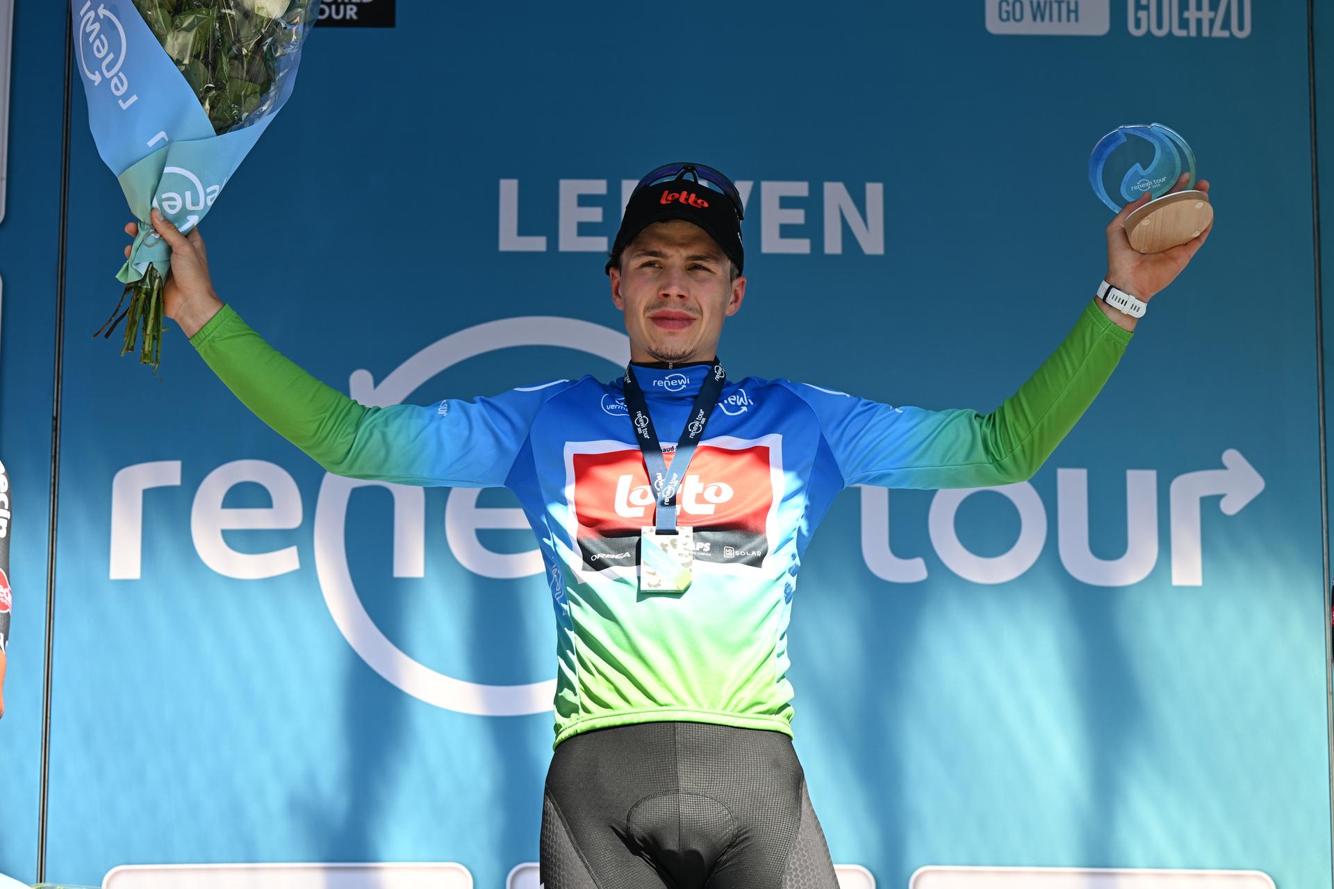 Belgian Arnaud De Lie of Lotto Cycling Team celebrates on the podium in the leader's jersey after winning the fifth and last stage of the 'Renewi Tour' multi-stage cycling race, 185km from and to Leuven on Sunday 24 August 2025. The five-day race takes place in Belgium and the Netherlands. BELGA PHOTO DAVID PINTENS
