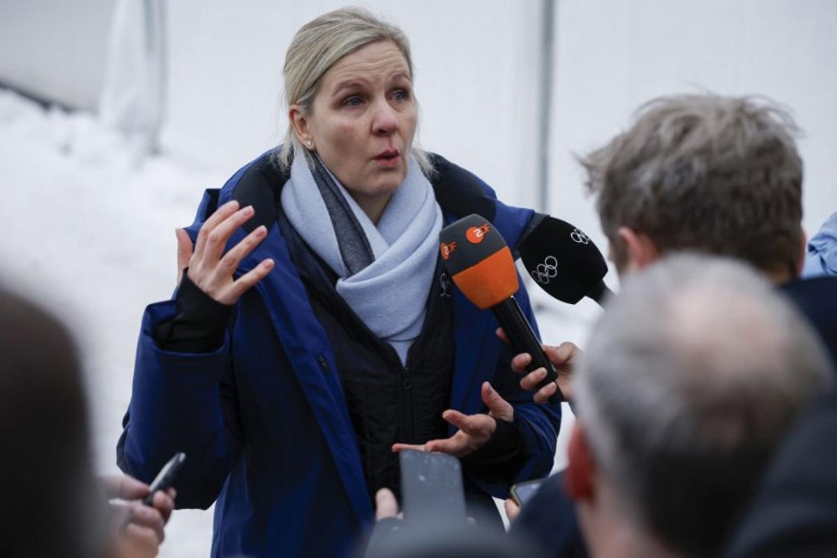 President of the International Olympic Committee (IOC) Kirsty Coventry speaks to the press after Ukraine's Vladyslav Heraskevych was disqualified from the Milano Cortina 2026 Winter Olympic Games in Cortina d'Ampezzo on February 12, 2026. Ukrainian skeleton racer Vladyslav Heraskevych was disqualified from the Winter Olympics on February 12, 2026 after refusing to back down over his banned helmet, which depicts victims of his country's war with Russia. In a statement, the International Olympic Committee said Heraskevych is "not allowed to participate at Milano-Cortina 2026 after refusing to adhere to the IOC athlete expression guidelines". Odd ANDERSEN / AFP