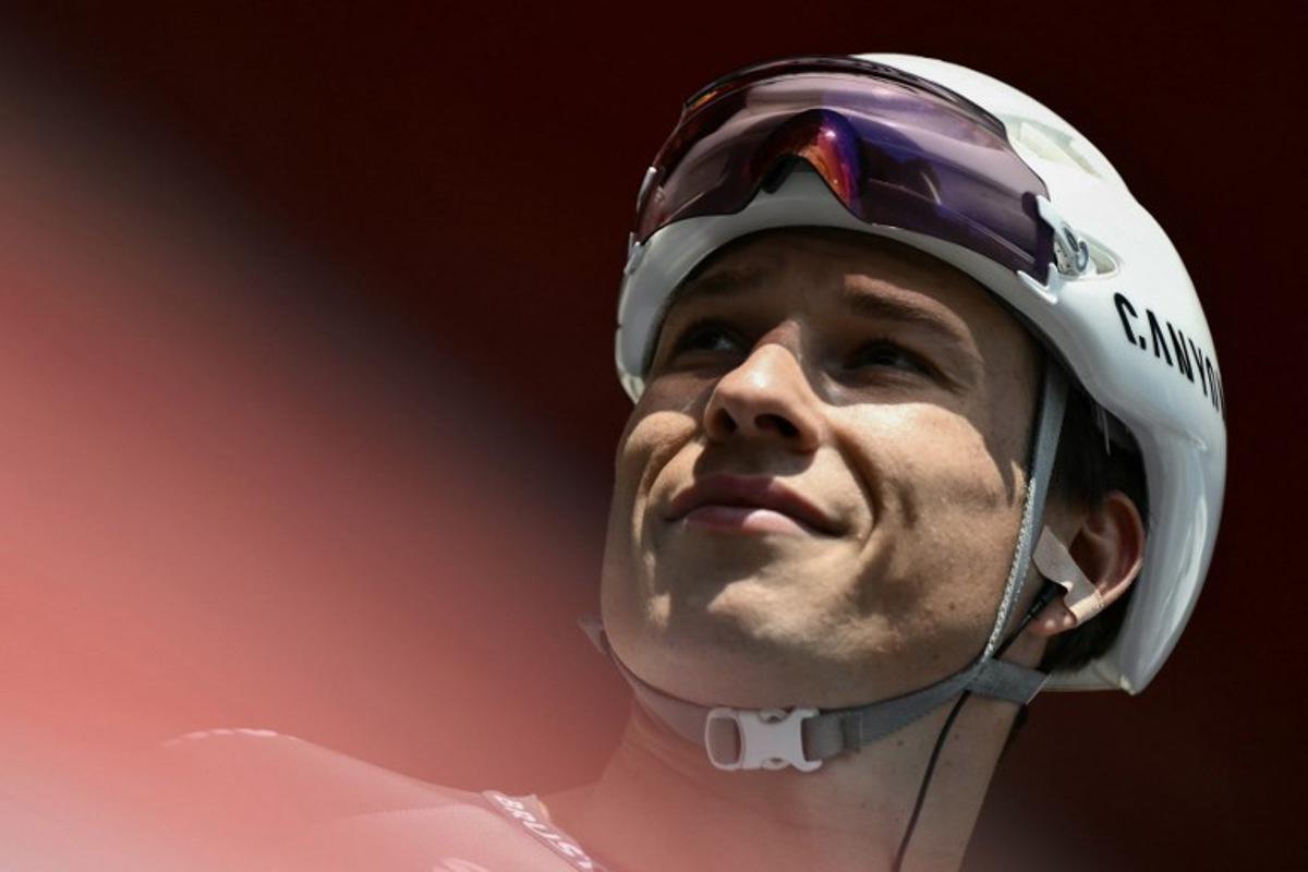 Team Alpecin's Belgian rider Jasper Philipsen is presented on stage before the start of the Vuelta a Espana, a 183 km race between Torino - Reggia di Venaria and Novara, in Italy's Piemonte region, on August 23, 2025. Marco BERTORELLO / AFP