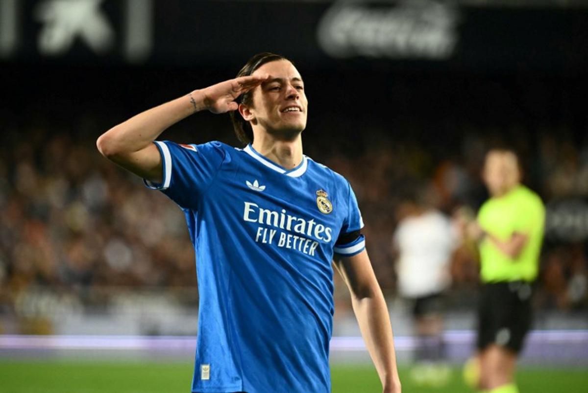 Real Madrid's Spanish defender #18 Alvaro Carreras celebrates scoring his team's first goal during the Spanish league football match between Valencia CF and Real Madrid CF at Mestalla Stadium in Valencia on February 8, 2026. JOSE JORDAN / AFP