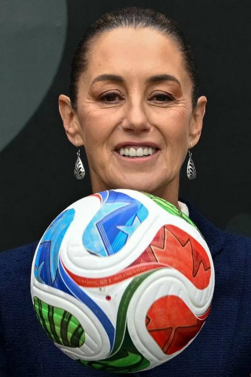 Mexican President Claudia Sheinbaum holds a FIFA Wold Cup 2026 official ball during a a presentation of the organization plan for the tournament in Mexico City, on November 10, 2025. CARL DE SOUZA / AFP