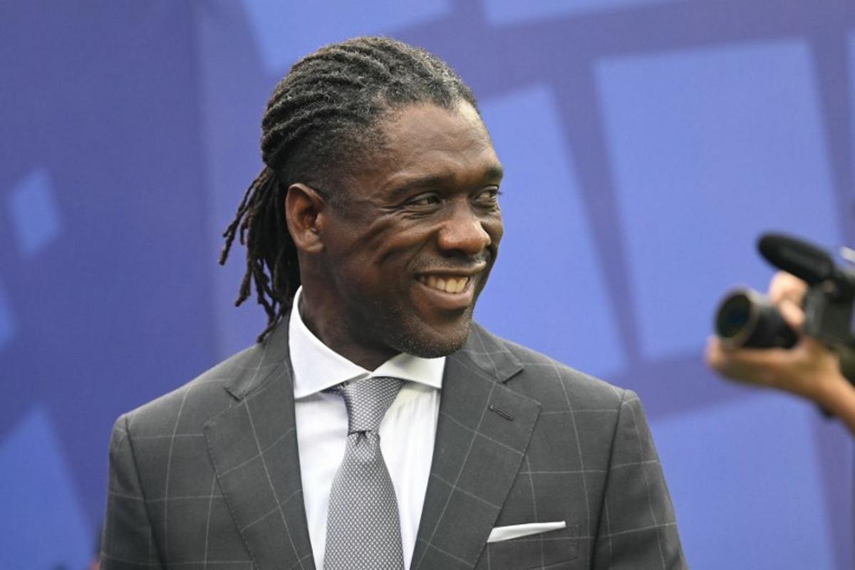 (FILES) Former Dutch football player Clarence Seedorf attends the 2026 World Cup round of 16 football match between Brazil and Norway at the New York/New Jersey Stadium in East Rutherford on July 5, 2026. Brazilian club Corinthians announced on October 11, 2026, the arrival of former Netherlands midfielder Clarence Seedorf as coach until the end of 2027 as they attempt to avoid relegation. MAURO PIMENTEL / AFP
