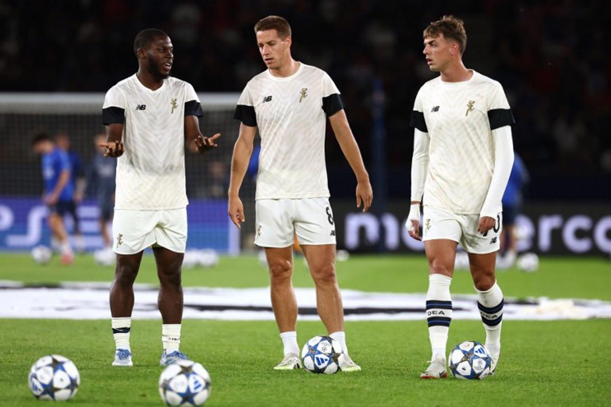 Atalanta's US midfielder #06 Yunus Musah (L), Atalanta's Croatian midfielder #08 Mario Pasalic (C) and Atalanta's Italian forward #70 Daniel Maldini (R) talk during the warm up ahead of the UEFA Champions League first round day 1 football match between Paris Saint-Germain (FRA) and Atalanta (ITA) at the Parc des Princes stadium in Paris on September 17, 2025. FRANCK FIFE / AFP