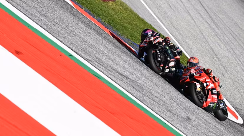 Aprilia Racing's Spanish driver Jorge Martin (L) and Ducati Lenovo Team's Spanish driver Marc Marquez compete during the Sprint event of the Grand Prix of Austria MotoGP in Spielberg bei Knittelfeld, Austria, on September 19, 2026. Joe Klamar / AFP