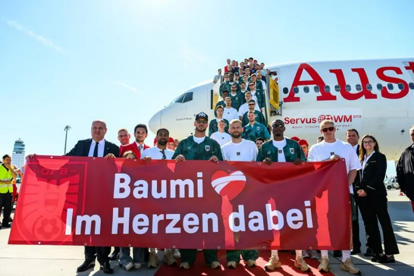 Members of Austria's national football team hold a banner reading "Baumi - with us in our hearts", addressing injured team player Christoph Baumgartner nicknamed "Baumi" who will miss the World Cup due to injury, as the team boards a plane before departing from the Schwechat airport near Vienna, Austria, on June 4, 2026, ahead of the FIFA 2026 World Cup. MAX SLOVENCIK / APA / AFP