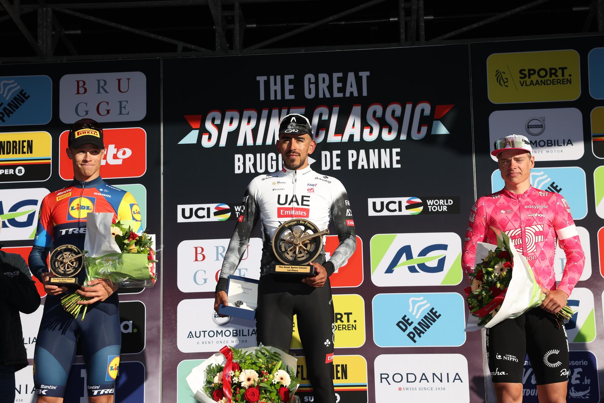Italian Jonathan Milan of Lidl-Trek, Colombian Juan Sebastian Molano of UAE Team Emirates and Estonian Madis Mihkels of EF Education-EasyPost celebrate on the podium of the 'Classic Brugge-De Panne' men's elite one-day cycling race, 195,6 km from Brugge to De Panne, Wednesday 26 March 2025. BELGA PHOTO KURT DESPLENTER