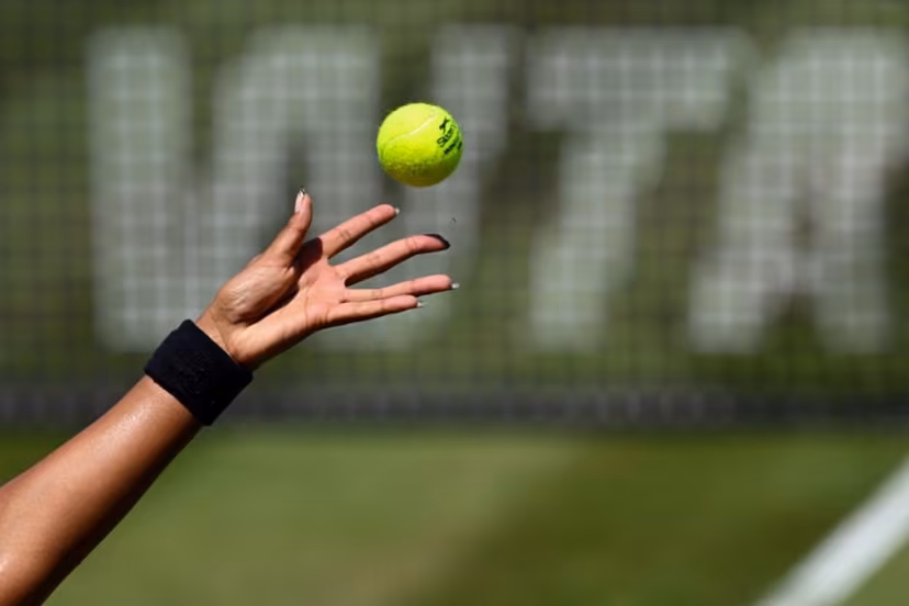 The hand of Japan's Naomi Osaka is pictured as she serves the ball while the WTA logo is seen in the background, during the women's singles quarter-final match of the WTA 500 Bad Homburg Open tennis tournament in Bad Homburg, western Germany on June 25, 2026. Kirill KUDRYAVTSEV / AFP