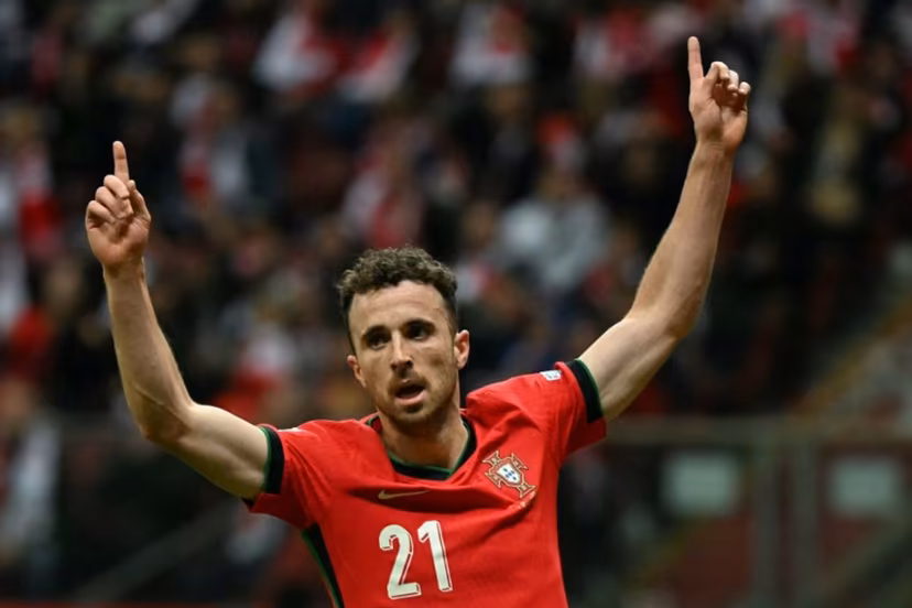 Portugal's forward #21 Diogo Jota reacts after Poland's defender #05 Jan Bednarek scored an own goal during the UEFA Nations League, League A Group A1 football match Poland vs Portugal at the National Stadium in Warsaw, Poland on October 12, 2024. Sergei GAPON / AFP
