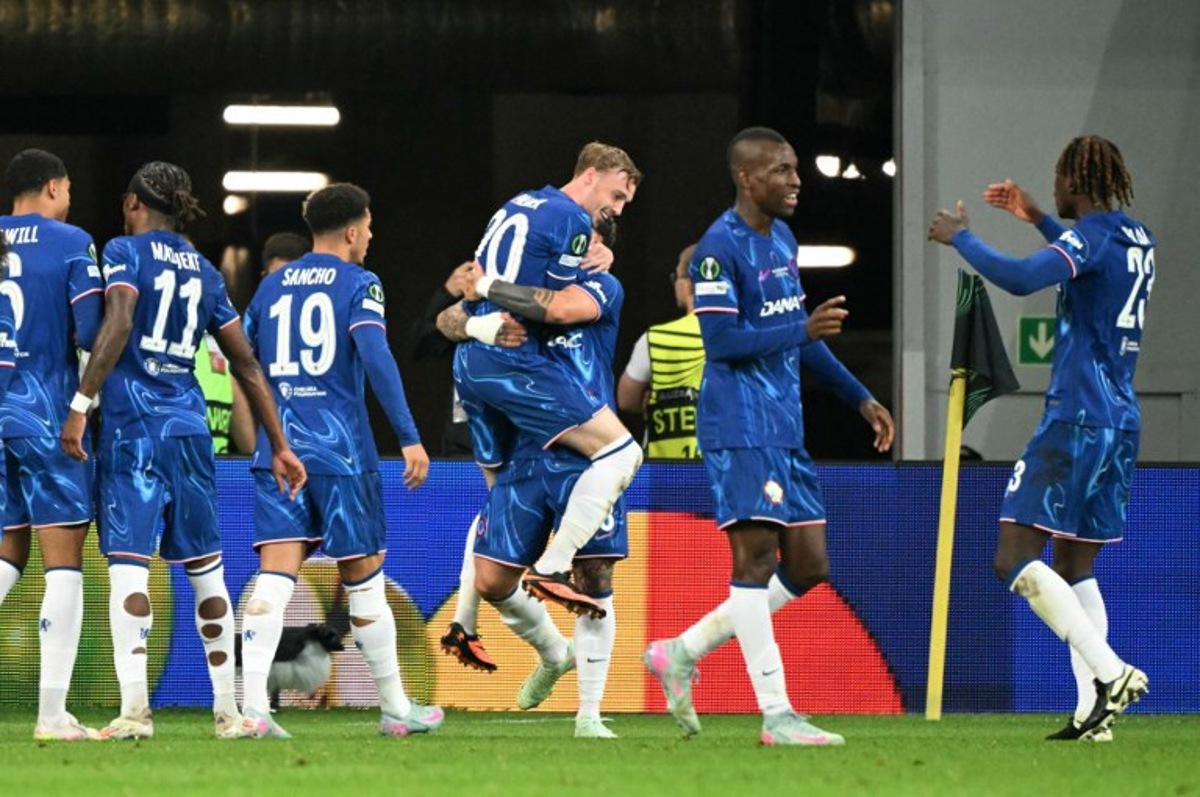 Chelsea's players celebrate after Chelsea's Argentinian midfielder #08 Enzo Fernandez scored his team's first goal during the UEFA Conference League final football match between Real Betis and Chelsea FC in Wroclaw on May 28, 2025. Sergei GAPON / AFP