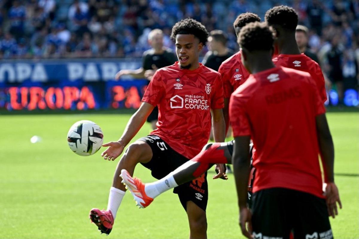 Reims' French defender #45 Therence Koudou (L) warms up prior to the French L1 football match between RC Strasbourg and Stade de Reims at the Stade de la Meinau, in Strasbourg, eastern France, on April 13, 2024. SEBASTIEN BOZON / AFP