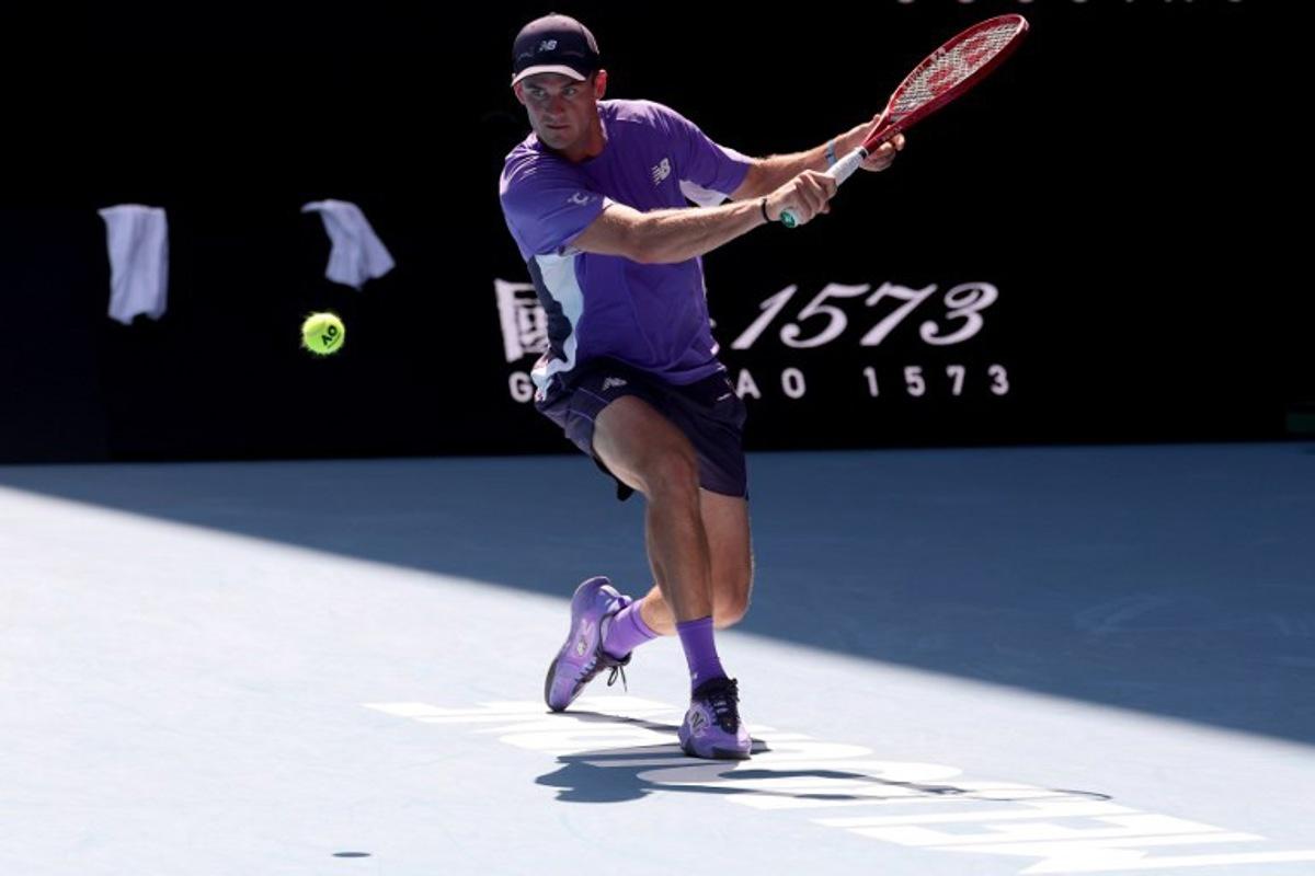USA's Tommy Paul hits a return to Spain's Carlos Alcaraz during their men's singles match on day eight of the Australian Open tennis tournament in Melbourne on January 25, 2026. DAVID GRAY / AFP