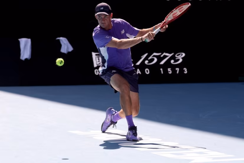 USA's Tommy Paul hits a return to Spain's Carlos Alcaraz during their men's singles match on day eight of the Australian Open tennis tournament in Melbourne on January 25, 2026. DAVID GRAY / AFP