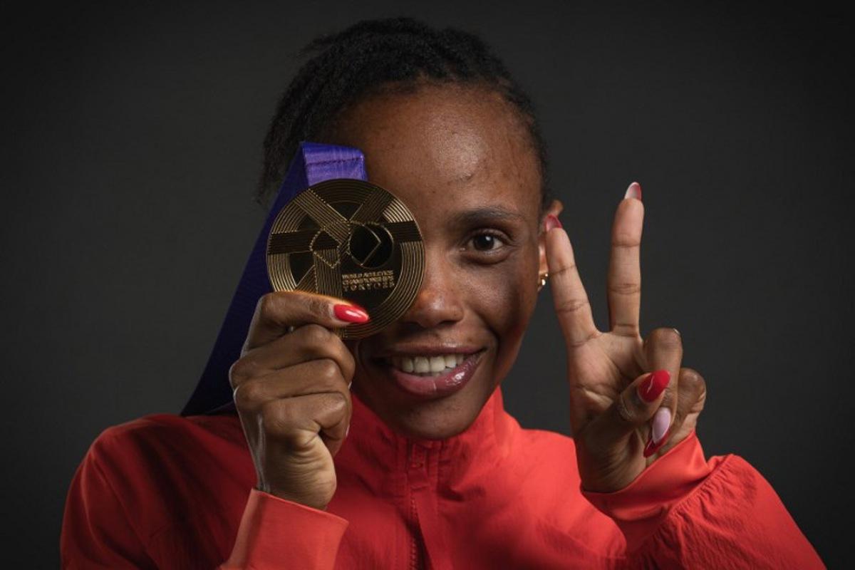 Gold medallist Kenya's athlete Beatrice Chebet poses for portraits after the women's 5000m final during a studio photo session on the sidelines of the World Athletics Championships in Tokyo on September 21, 2025. Andrej ISAKOVIC / AFP