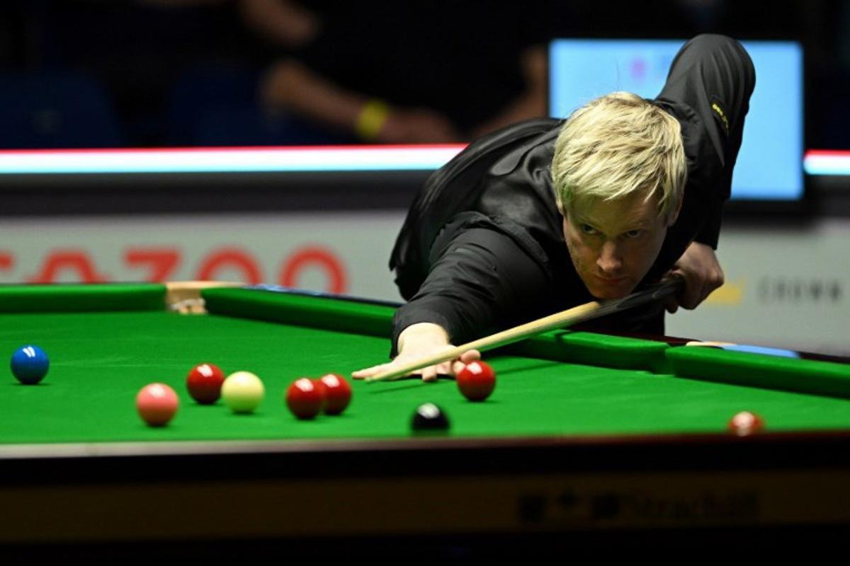 Australia's Neil Robertson plays a shot as he competes against Wales' Jamie Jones during round 4 of the qualifiers for the 2024 World Snooker Championship in the English Institute of Sport in Sheffield on April 17, 2024. Oli SCARFF / AFP