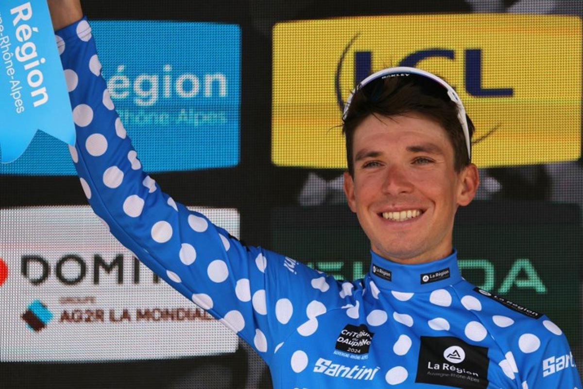Team Astana's Italian rider Lorenzo Fortunato celebrates with the climber's dotted jersey on the podium after the eighth and last stage of the 76th edition of the Criterium du Dauphine cycling race, 160,6km between Thones and Plateau des Glieres, near Thorens-Glieres, French Alps, on June 9, 2024. Thomas SAMSON / AFP
