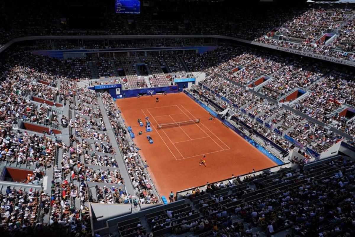 Spectators watch the men's singles quarter-final tennis match between Spain's Carlos Alcaraz and US' Tommy Paul on Court Philippe-Chatrier at the Roland-Garros Stadium during the Paris 2024 Olympic Games, in Paris on August 1, 2024. Dimitar DILKOFF / AFP