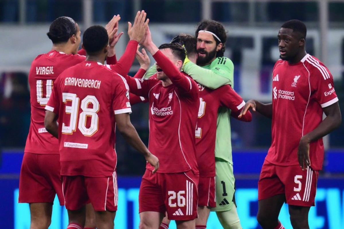 Liverpool players celebrate after winning the UEFA Champions League phase day 6 football match between Inter Milan and Liverpool at San Siro stadium in Milan, on December 9, 2025. Stefano RELLANDINI / AFP