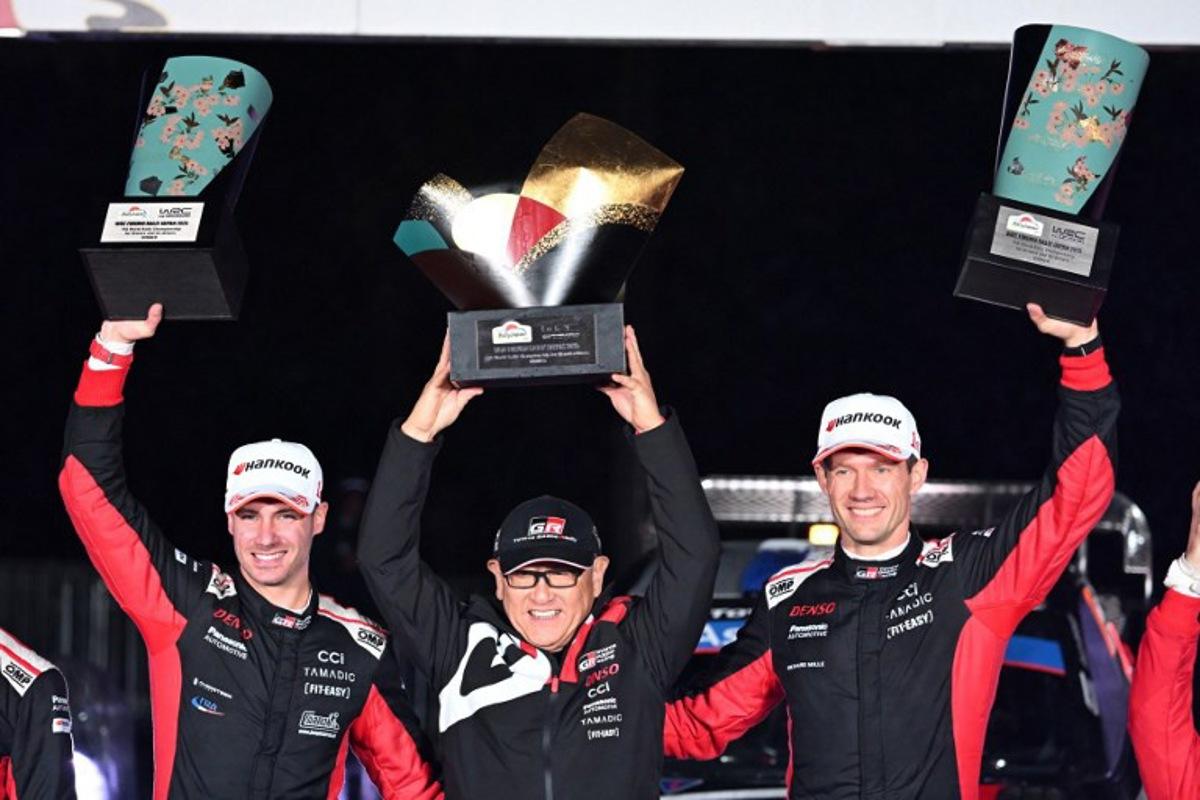 Sebastien Ogier (R) and his co-driver Vincent Landais (L) of France celebrate their victory with Toyota Gazoo Racing chairman Akio Toyoda (C) during the podium ceremony of the Rally Japan, the 13th round of the FIA World Rally Championships, in Toyota city, Aichi prefecture on November 9, 2025. Toshifumi KITAMURA / AFP