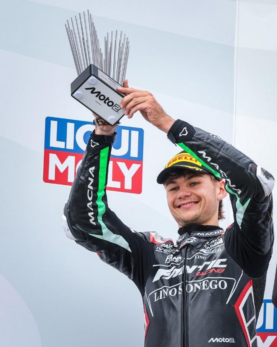 Second-placed Fantic Racing Team's Belgiums Moto2 rider Barry Baltus celebrates on the podium with his trophy after the German Moto2 Grand Prix at the Sachsenring racing circuit, in Hohenstein-Ernstthal near Chemnitz, eastern Germany on July 13, 2025. Ronny Hartmann / AFP