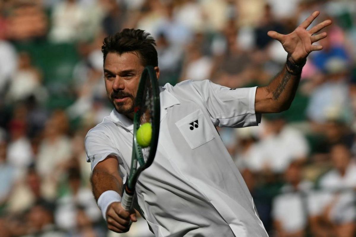 Switzerland's Stan Wawrinka returns to Italy's Matteo Berrettini during their men's singles first round tennis match on the second day of the 2026 Wimbledon Championships at The All England Lawn Tennis and Croquet Club in Wimbledon, southwest London, on June 30, 2026. Glyn KIRK / AFP