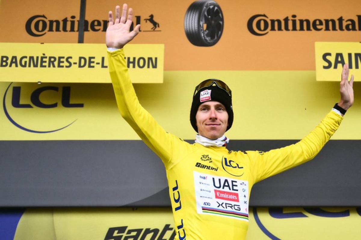 UAE Team Emirates - XRG team's Slovenian rider Tadej Pogacar celebrates on the podium with the overall leader's yellow jersey after the 14th stage of the 112th edition of the Tour de France cycling race, 182.6 km between Pau and Luchon-Superbagneres, in the Pyrenees mountains of southwestern France, on July 19, 2025. Marco BERTORELLO / AFP