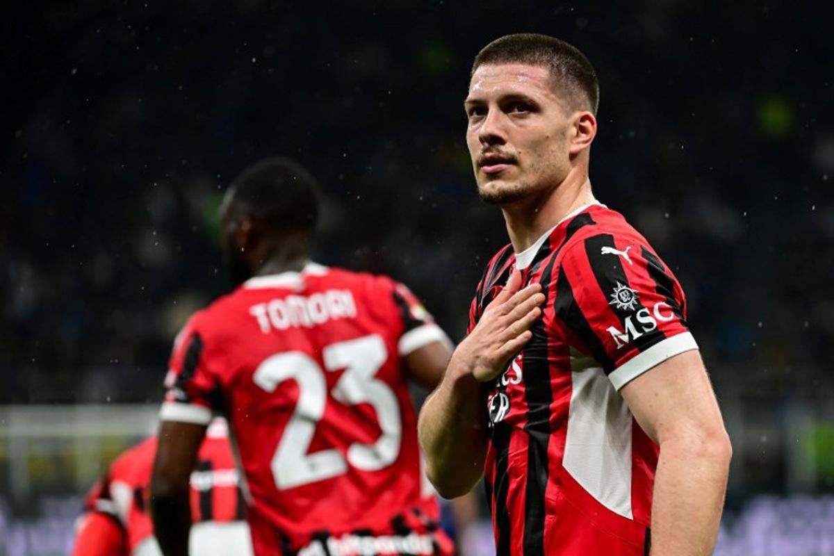 AC Milan's Serbian forward #09 Luka Jovic (R) celebrates after scoring AC Milan's first goal during the Coppa Italia second leg semi-final football match between Inter Milan and AC Milan at the San Siro stadium in Milan on April 23, 2025. Piero CRUCIATTI / AFP