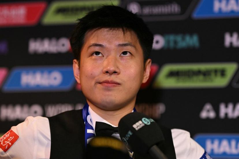 China's Zhao Xintong reacts at a press conference after victory over Wales' Mark Williams in the World Championship Snooker final at The Crucible in Sheffield, northern England on May 5, 2025. Zhao Xintong became the first Chinese player to win the World Snooker Championship as the qualifier completed his stunning march to the title with a 18-12 victory against Mark Williams in the final on Monday. Oli SCARFF / AFP