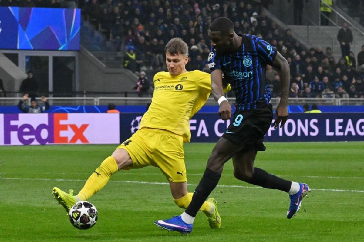 Inter Milan's French forward #09 Marcus Thuram (R) shoots past Bodo/Glimt's Norwegian defender #04 Odin Bjortuft during the UEFA Champions League second-leg play-off football match between Inter Milan and Bodo/Glimt at San Siro stadium in Milan, northern Italy, on February 24, 2026. Andreas SOLARO / AFP