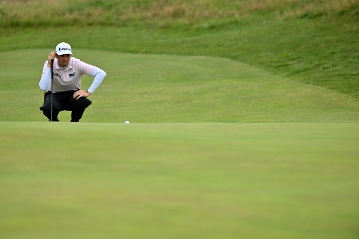US golfer JT Poston lines up a putt on the 14th green on day three of the 151st British Open Golf Championship at Royal Liverpool Golf Course in Hoylake, north west England on July 22, 2023. The 151st Open at The Royal Liverpool Golf Course is set to run until July 23. Glyn KIRK / AFP