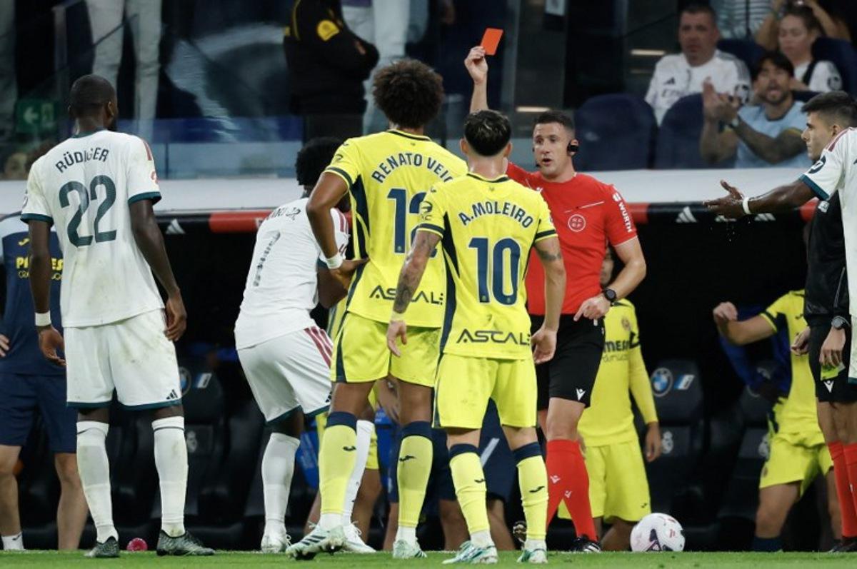 Referee Isidro Escuderos shows a red card to Real Madrid's Brazilian forward #07 Vinicius Junior (2L) during the Spanish league football match between Real Madrid CF and Villarreal CF at the Santiago Bernabeu Stadium in Madrid on October 10, 2026. Oscar DEL POZO / AFP