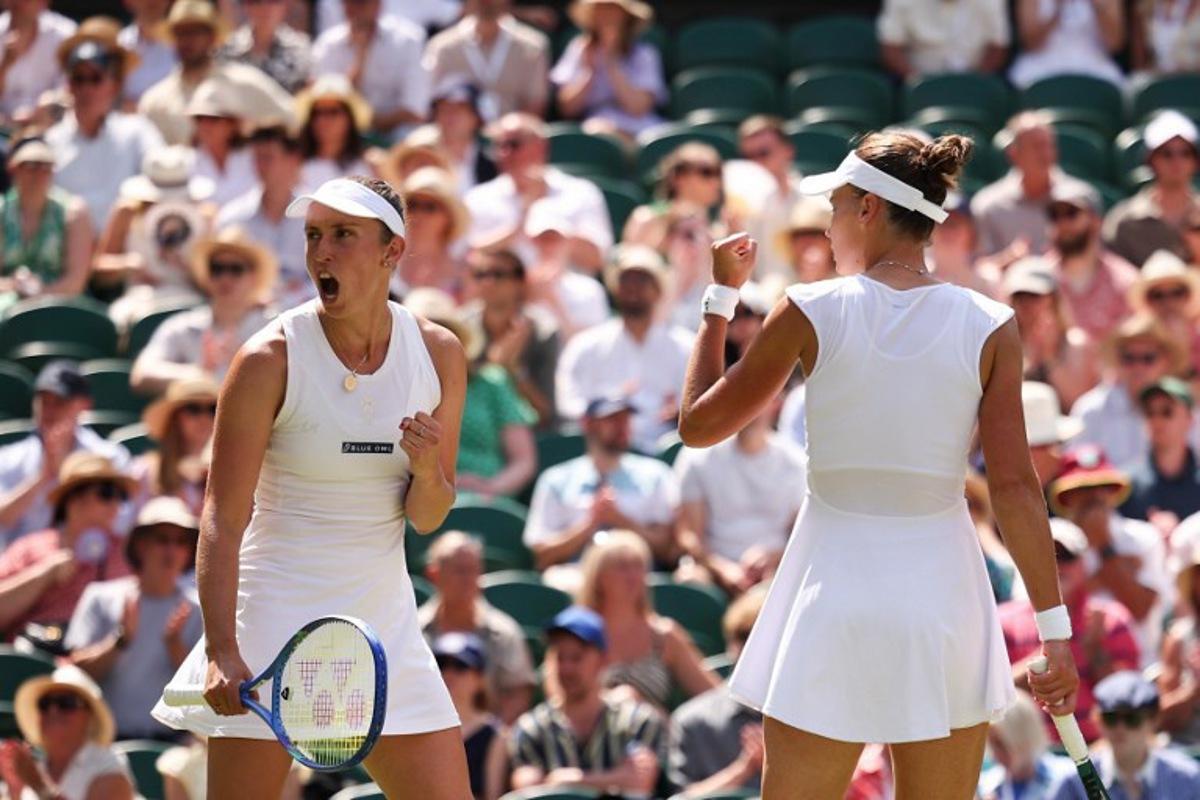 Russia's Veronika Kudermetova (R) and Belgium's Elise Mertens react after a point as they play against Taiwan's Hsieh Su-wei and Latvia's Jelena Ostapenko during their women's doubles final tennis match on the fourteenth day of the 2025 Wimbledon Championships at The All England Lawn Tennis and Croquet Club in Wimbledon, southwest London, on July 13, 2025. HENRY NICHOLLS / AFP