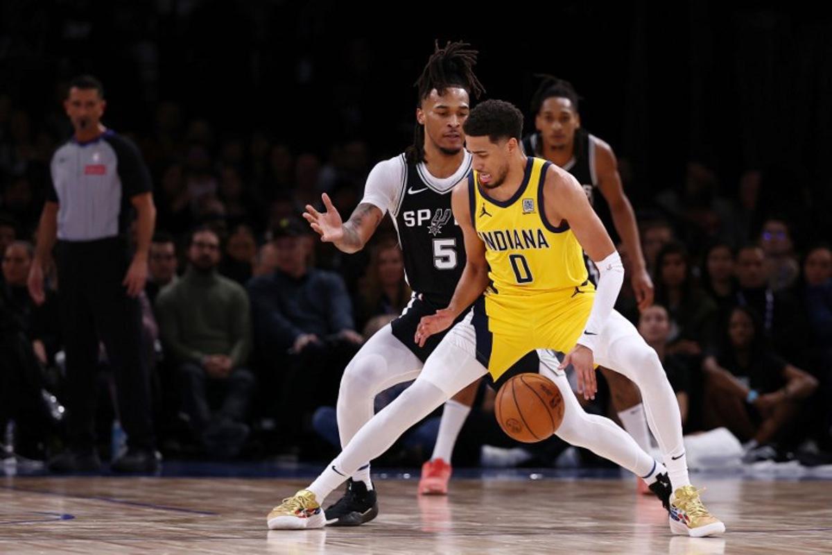 Indian Pacer's US Guard #0 Tyrese Haliburton (R) dribbles the ball as San Antonio Spurs' US guard #05 Stephon Castle (L) during the NBA basketball game between the San Antonio Spurs and the Indiana Pacers at the Accor Arena - Palais Omnisports de Paris-Bercy - in Paris on January 25, 2025. FRANCK FIFE / AFP