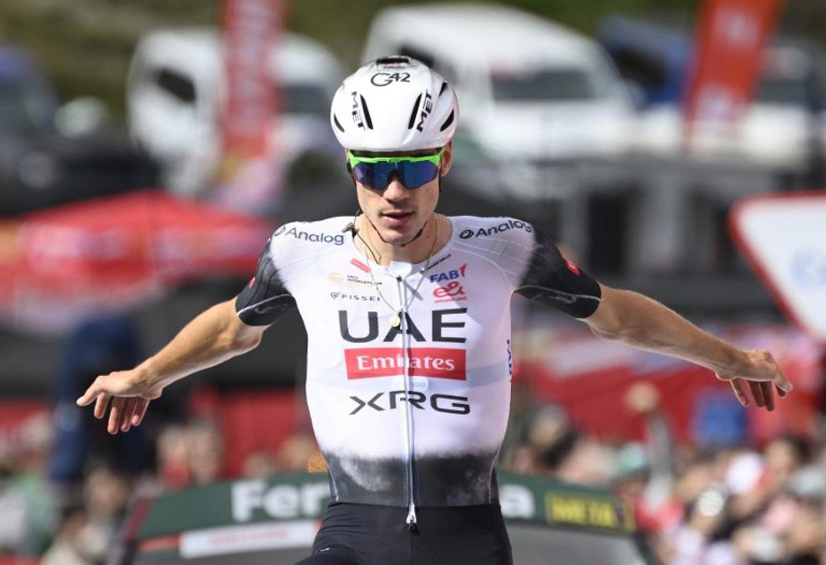 Team UAE's Spanish rider Juan Ayuso gestures as he celebrates crossing first the finish line during the seventh stage of the Vuelta a Espana, a 187 km race between Andorra la Vella and Cerler, on August 29, 2025. Josep LAGO / AFP