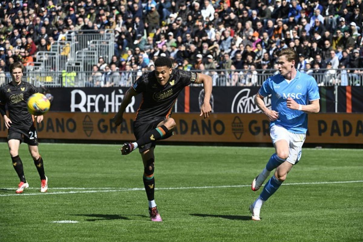 Venezia's Belgian defender #25 Joel Schingtienne fights for the ball with Napoli's Scottish midfielder #08 Scott Mc Tominay (R) during the Italian Serie A football match between Venezia and Napoli at the Pier Luigi Penzo Stadium, on March 23, 2025 in Venice. ANDREA PATTARO / AFP