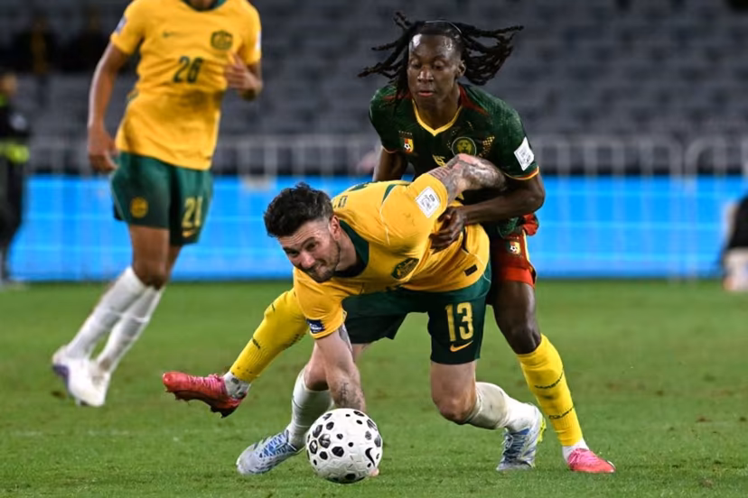 Australia's Aiden O'Neill (L) reacts after being tackled by Cameroon's Ryan Fosso (R) during the international friendly football match between Australia and Cameroon at Stadium Australia in Sydney on March 27, 2026. SAEED KHAN / AFP