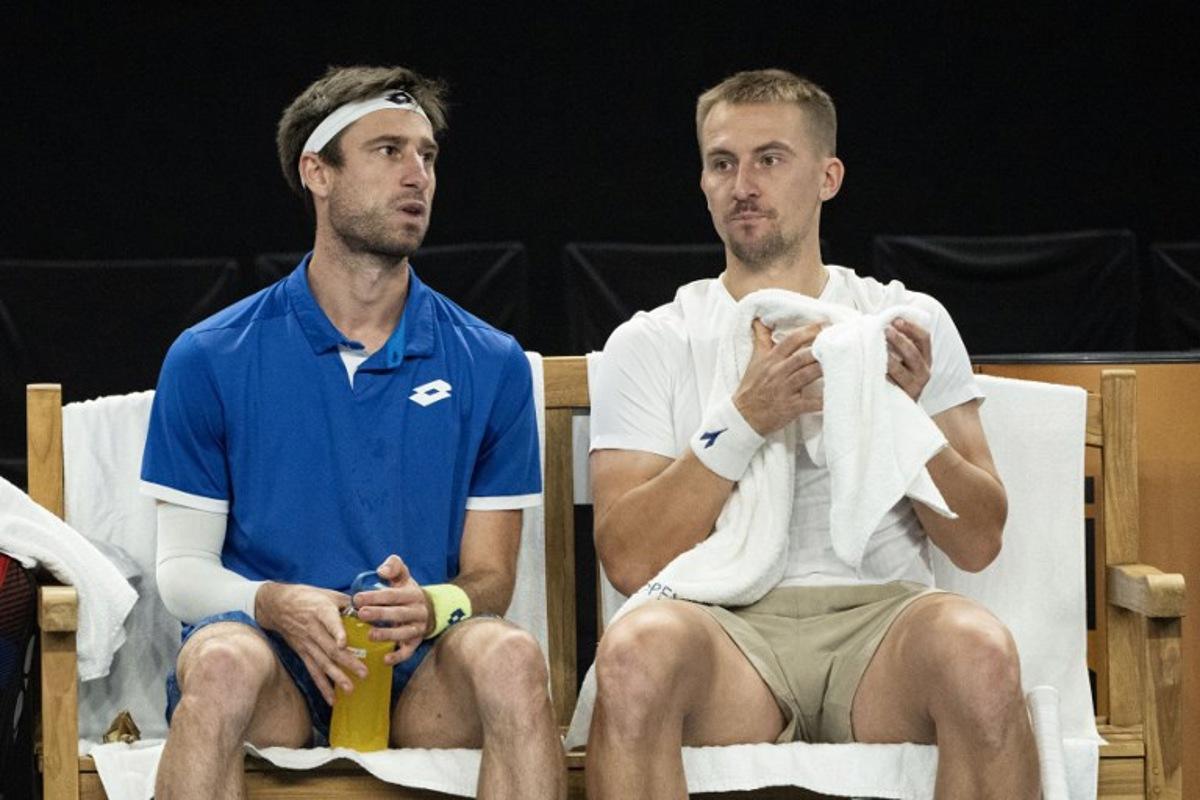 Belgium's Sander Gille (L) and Poland's Jan Zielinski (R) rest in a break during their men's doubles final tennis match against France's Benjamin Bonzi and France's Pierre-Hughes Herbert at the Marseille Open 13 ATP World Tour in Marseille, southern France on February 16, 2025. MIGUEL MEDINA / AFP