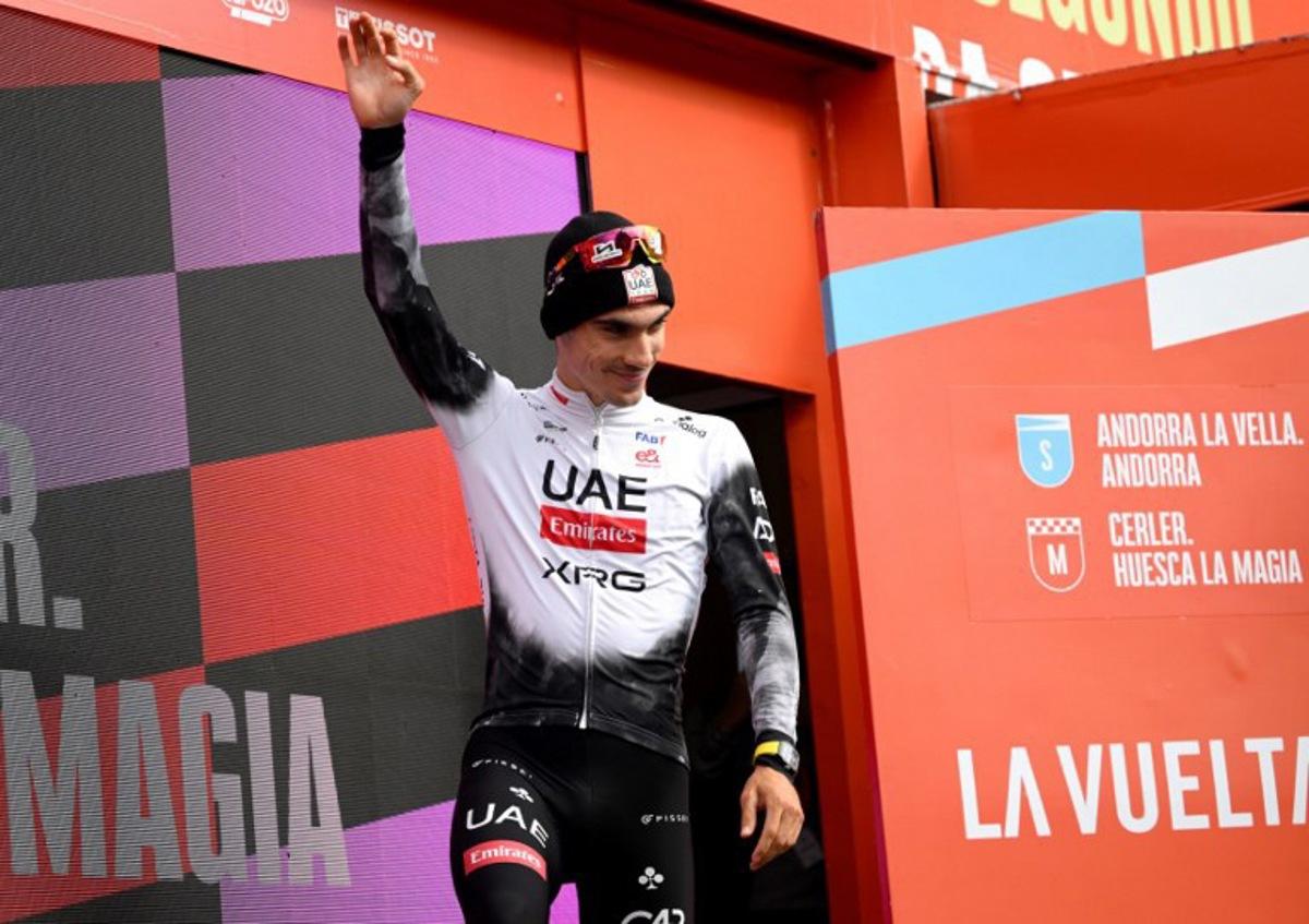 Team UAE's Spanish rider Juan Ayuso celebrates on the podium after winning the seventh stage of the Vuelta a Espana, a 187 km race between Andorra la Vella and Cerler, on August 29, 2025. Josep LAGO / AFP