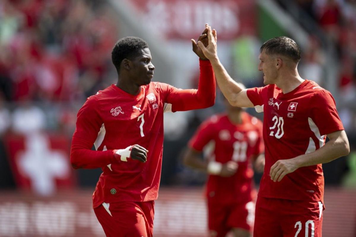 Switzerland's forward #7 Breel Embolo (L) celebrates with Switzerland's midfielder #20 Michel Aebischer scoring his team's first goal during a friendly football match between Switzerland and Jordan ahead of the 2026 FIFA World Cup football tournament at the Kybunpark stadium in St. Gallen on May 31, 2026. Ennio LEANZA / AFP