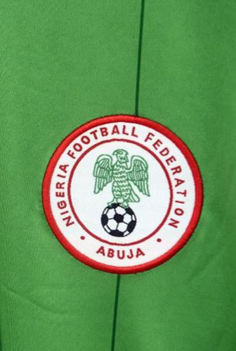 A logo f the Nigerian national football team is pictured on an official jersey for the 2014 World Cup on May 17, 2014 in Lagos. AFP PHOTO/PIUS UTOMI EKPEI
