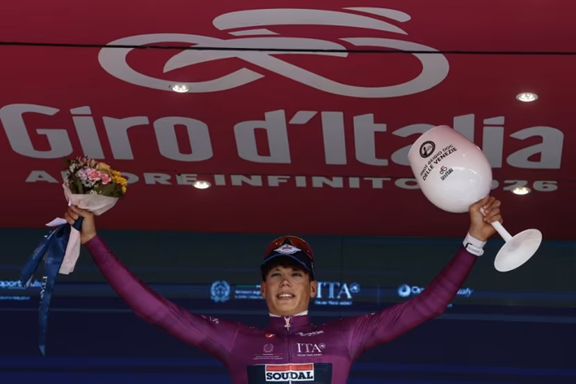 Soudal Quick-Step French rider Paul Magnier celebrates his mauve jersey (Maglia Ciclamino) of best sprinter on the podium after the 10th stage of the Giro d'Italia 2026 - Tour of Italy cycling race, 42km individual time trial between Viareggio and Massa on May 19, 2026. , Luca Bettini / AFP