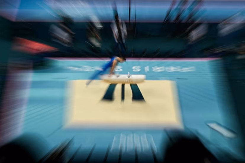 This zooming effet photograph shows an athlete practising in the artistic gymnastics men's pommel horse final during the Paris 2024 Olympic Games at the Bercy Arena in Paris, on August 3, 2024. Gabriel BOUYS / AFP