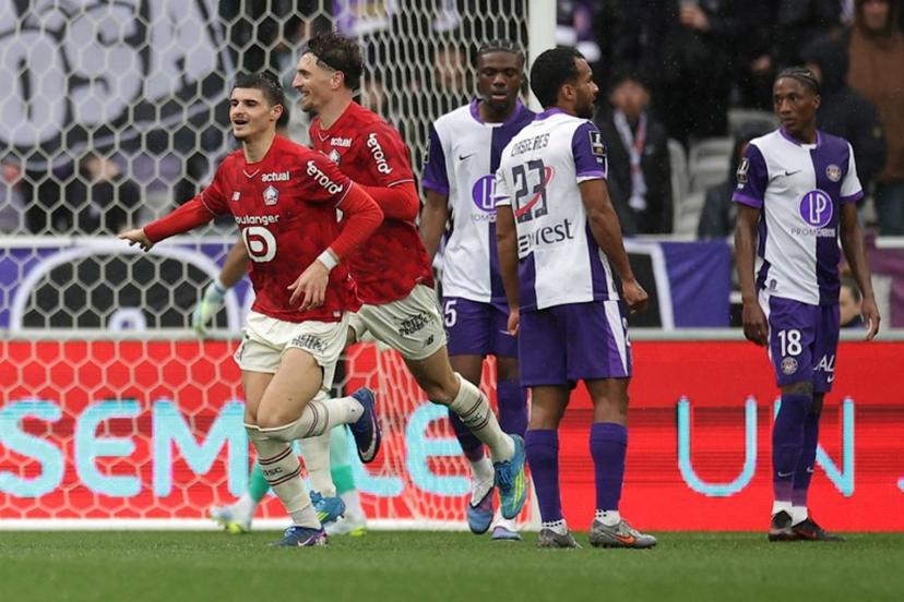 Lille's players celebrate after scoring the team first goal during the French L1 football match between Toulouse FC and Lille LOSC at the TFC Stadium in Toulouse, southwestern France, on April 12, 2026. Valentine CHAPUIS / AFP