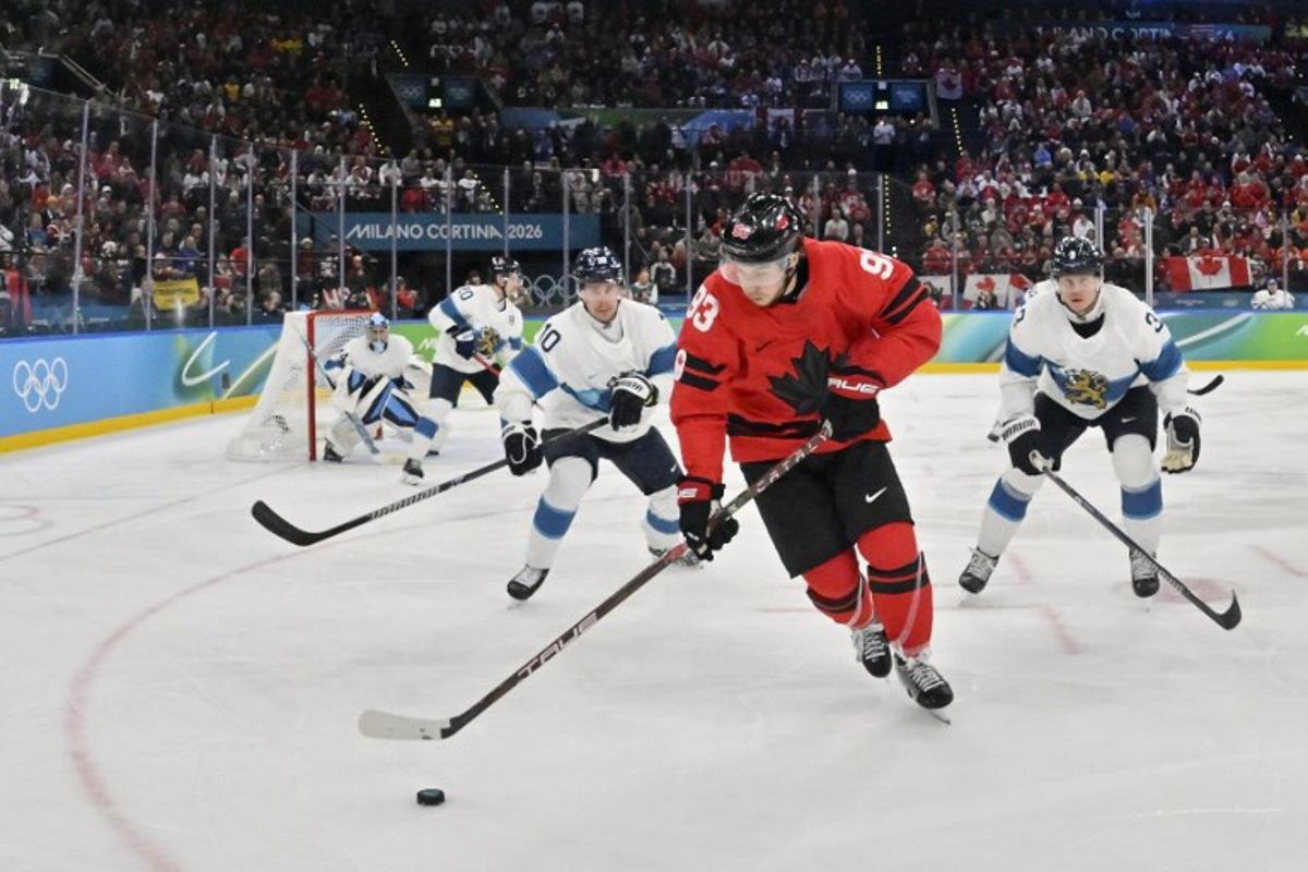 Canada's #93 Mitch Marner (C) controls the puck during the men's play-off semi-final ice hockey match between Canada and Finland at the Milano Santagiulia Ice Hockey Arena during the Milano Cortina 2026 Winter Olympic Games in Milan, on February 20, 2026. Alexander NEMENOV / AFP