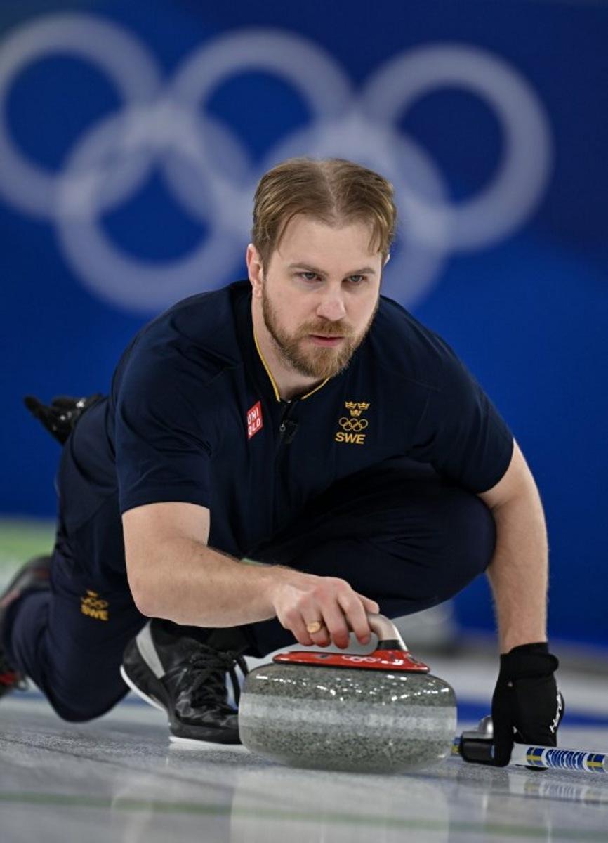 Sweden's Rasmus Wrana competes in the curling mixed doubles round robin gold medal game between Sweden and USA during the Milano Cortina 2026 Winter Olympic Games at the Cortina Curling Olympic Stadium in Cortina d'Ampezzo on February 10, 2026. François-Xavier MARIT / AFP